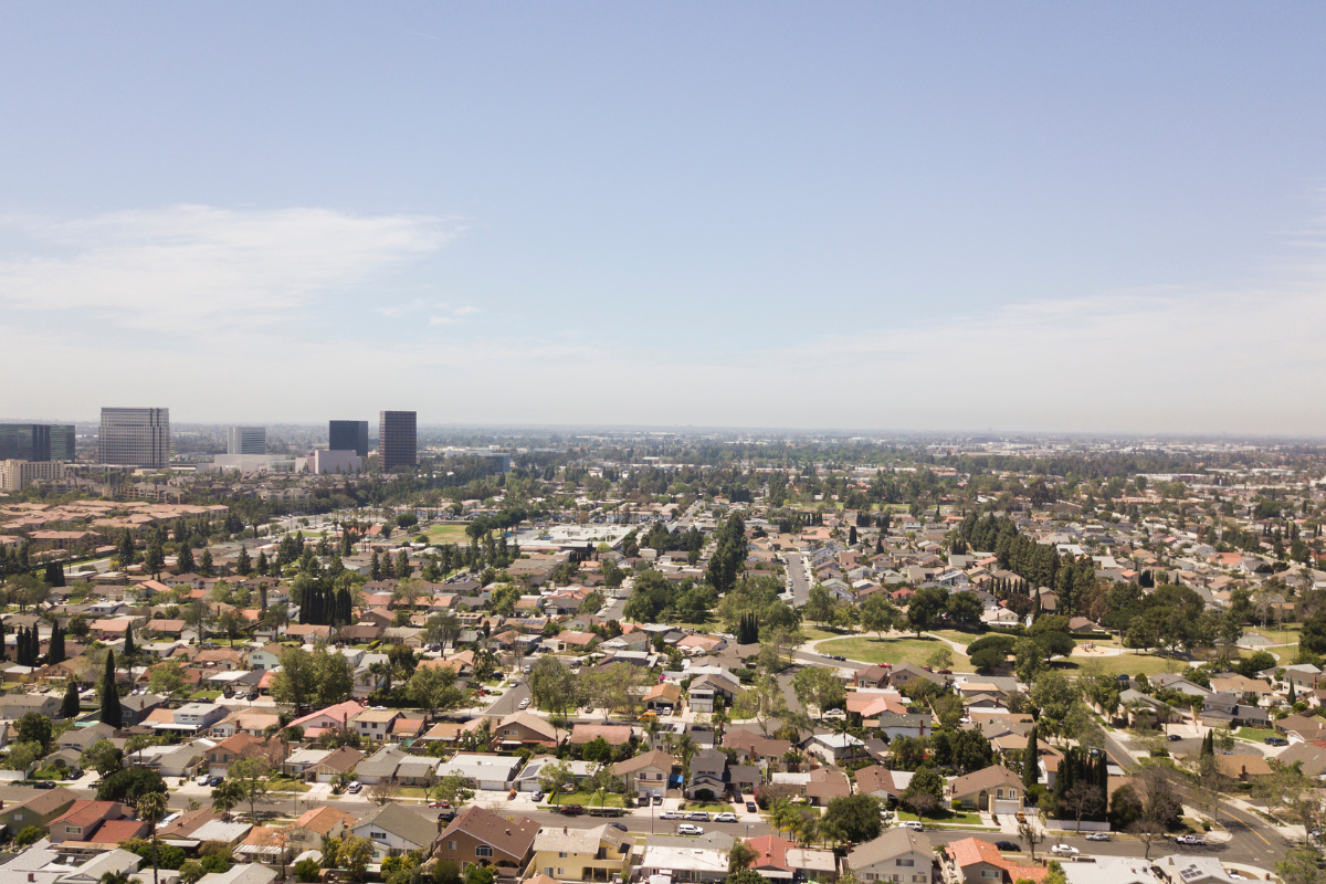 Aerial view of Costa Mesa neighborhoods and skyline on a clear spring day