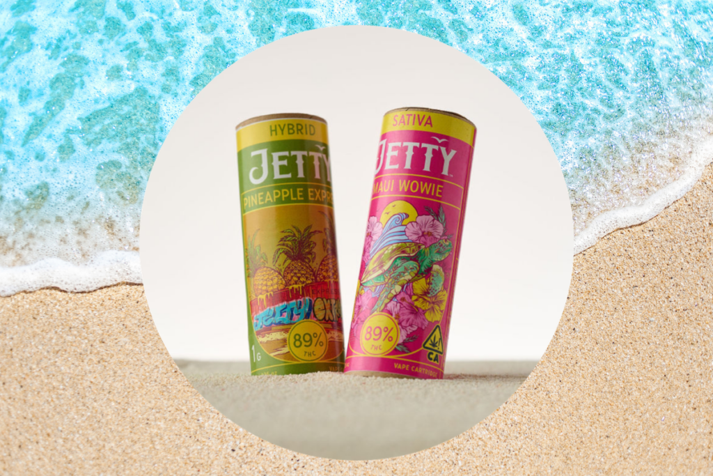 Two Jetty vape cartridge packages labeled Pineapple Express and Maui Wowie on a beach background